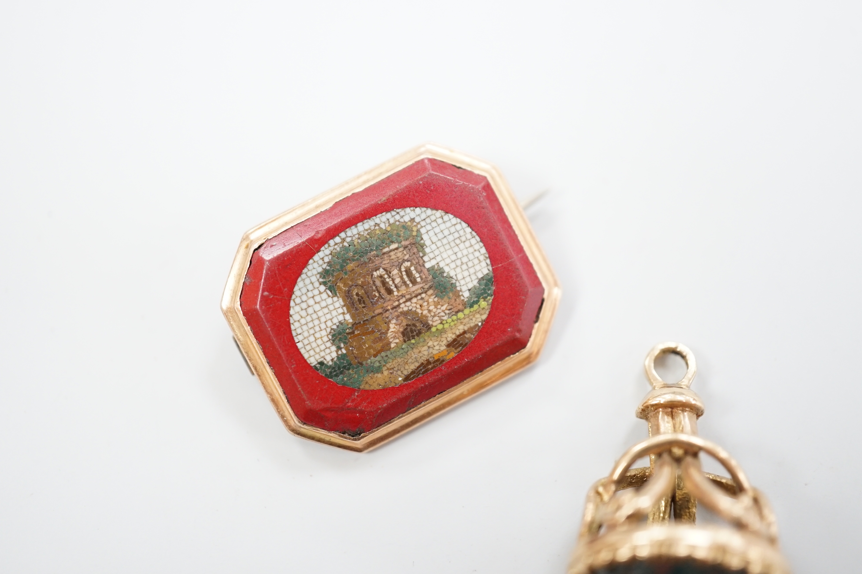 A 19th century yellow metal and micro mosaic set brooch, 23mm and a similar yellow metal overlaid and bloodstone set fob seal.
